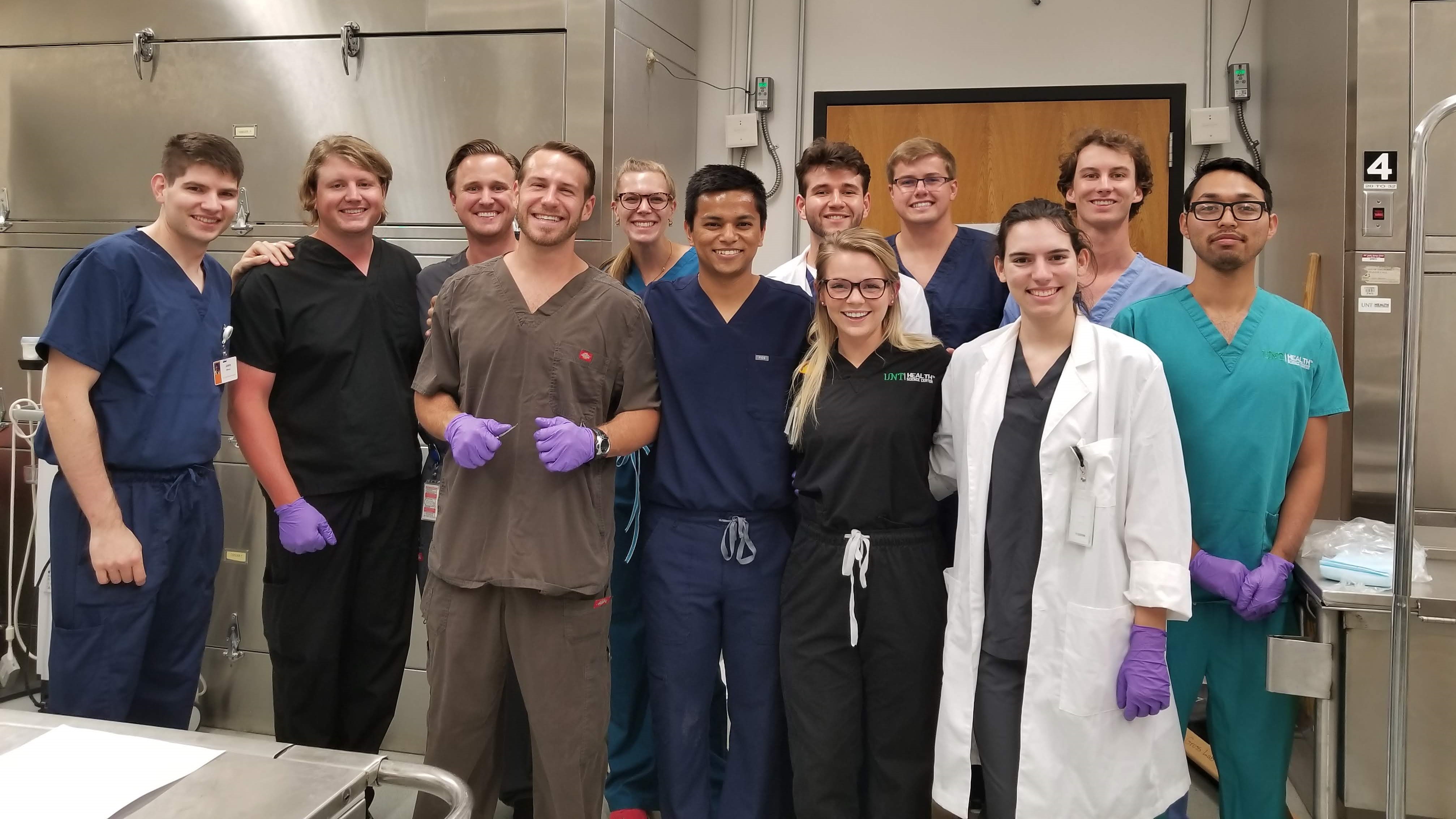 students in lab scrubs posing for a group photo