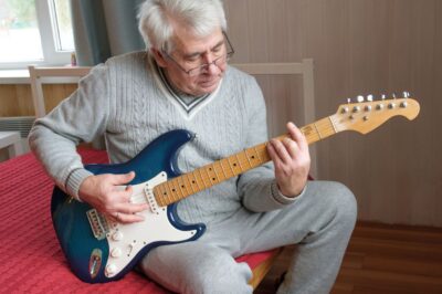 Older Man Playing Electric Guitarsm
