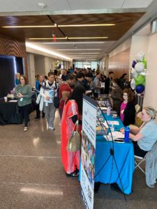Image of people attending the Pharmacy Showcase Event visiting table displays
