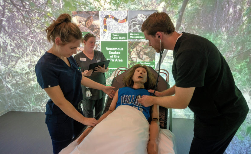 School of Health Professions students working on a dummy in the sim center