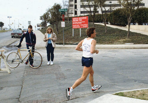 Marathon runner from early Cowtown Marathon, running past UNTHSC campus