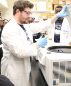 A professor instructing science students.