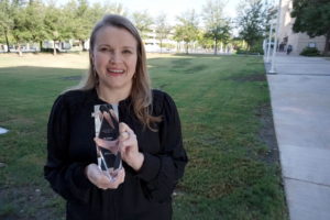 Brittany Brookens holding an award.