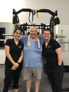 Two trainers posing with a patient