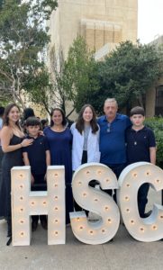 Godoy family standing in front of the letters HSC