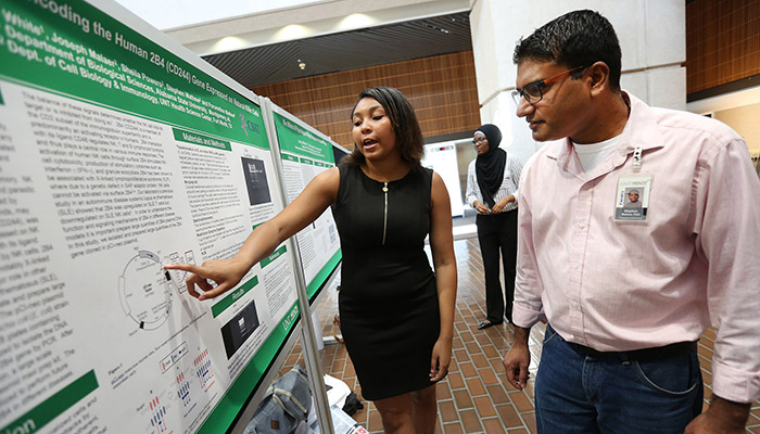 Student and faculty at poster presentation