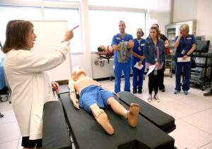Dr. Nancy Tioerney teaching students in HSC's old Simulation Lab. 