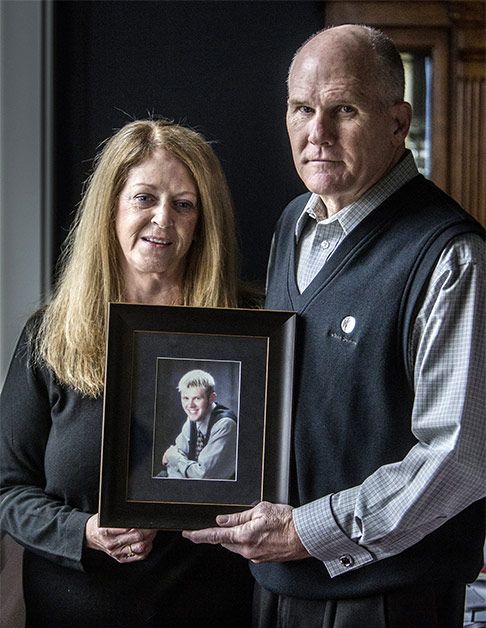 Kathy and David Meincke holding a photo of Jeff