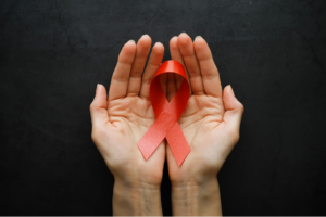 a person holding a red ribbon in their hands