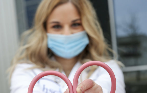 a student folding their stethoscope in to a heart