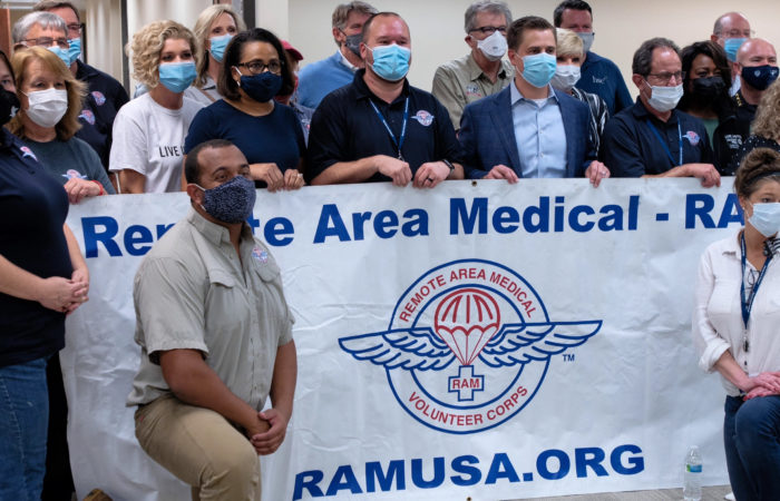 group photo of ram event volunteers posing with a banner of the ramusa.org logo